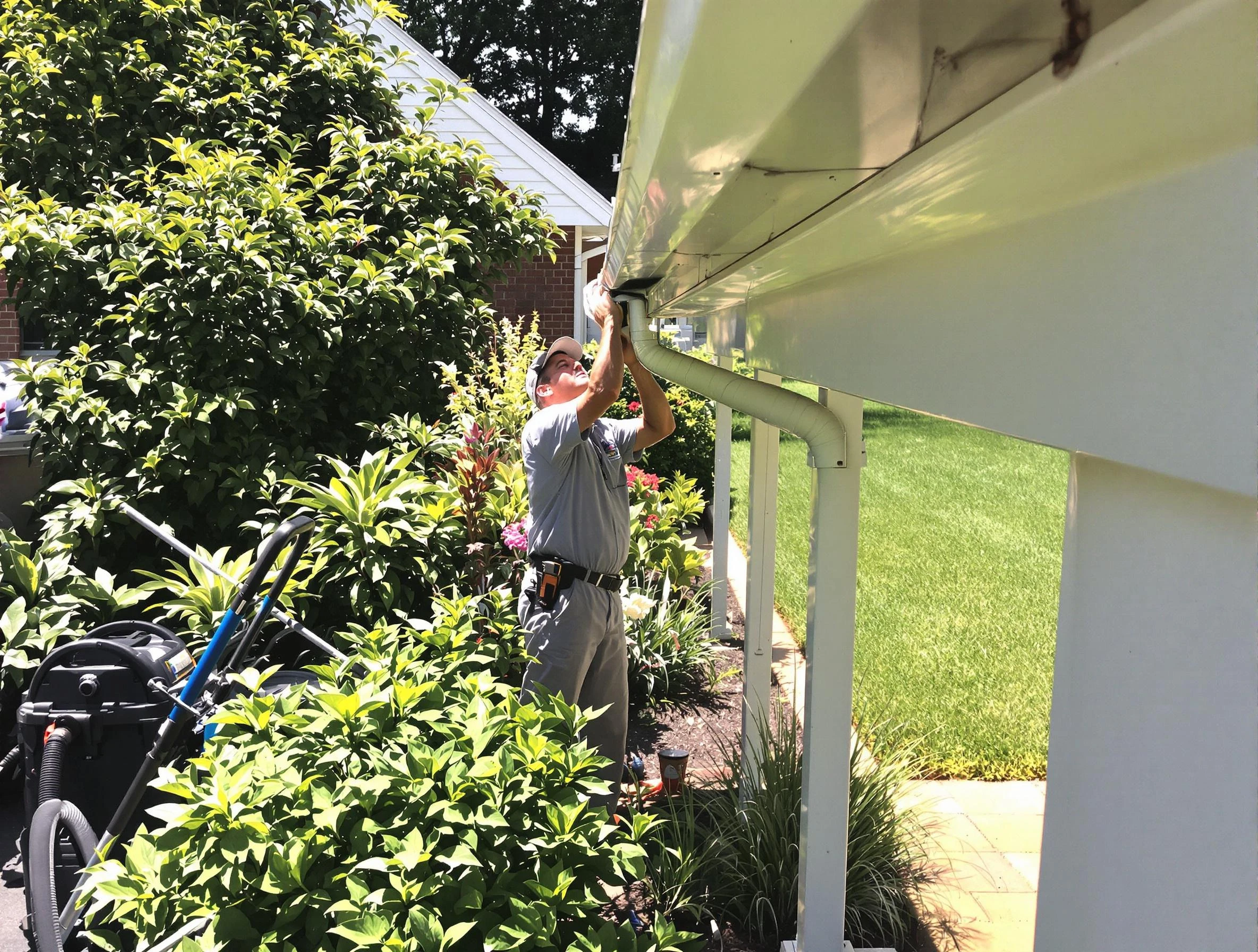 Technician flushing a blockage from a downspout in Garfield Heights, OH